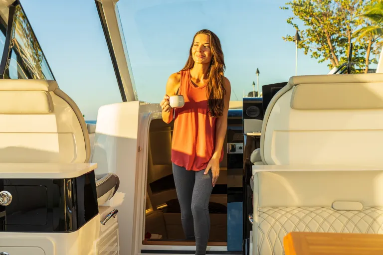 2026-Sundancer-370-Outboard-DAO370-lifestyle-woman-cockpit-cabin-access-door-06554-X4